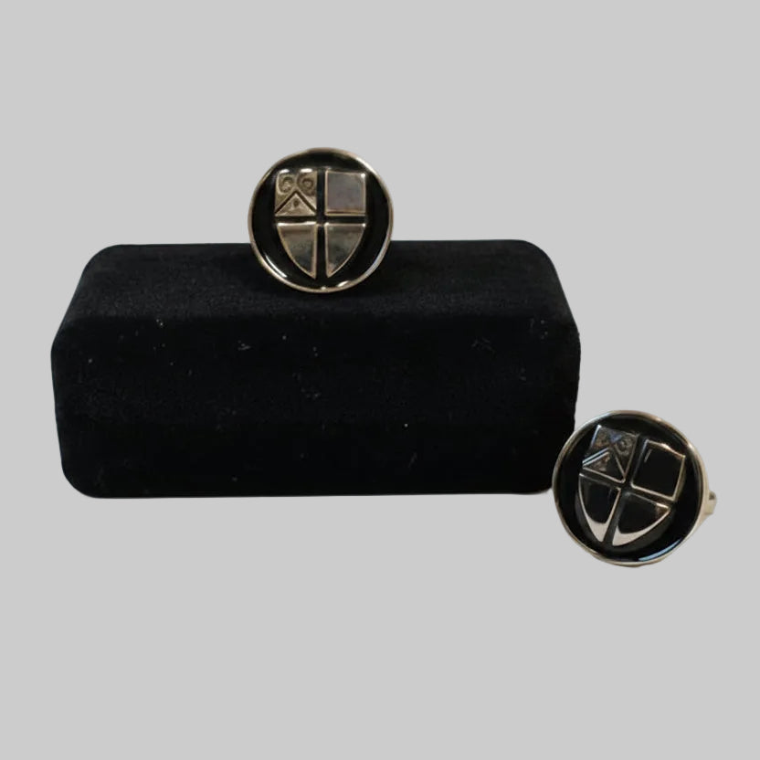 Round cufflinks with gold Durham University crest with a black background. Cufflinks are displayed on a black case which is included with the product.